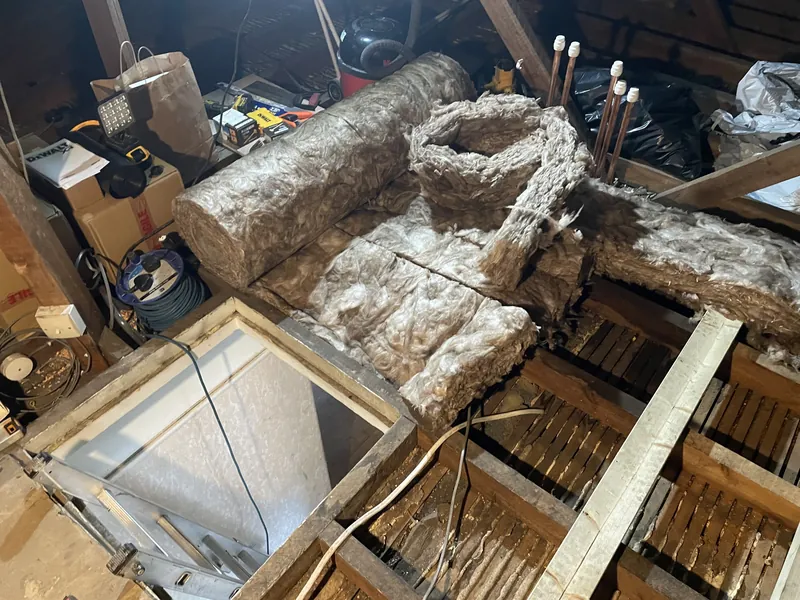 Loft boarding & water tank platform: Before: loose insulation around the loft hatch