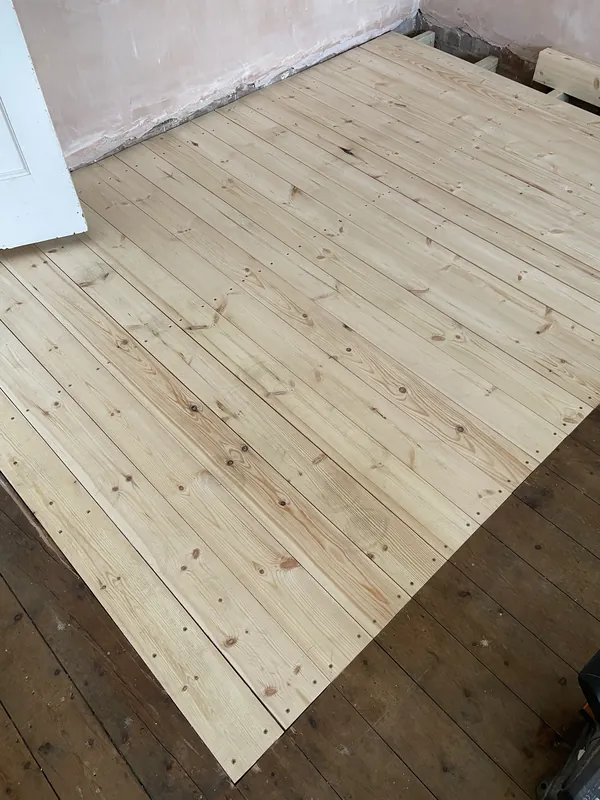 New pine floorboards laid over repaired joists